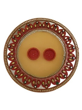 Plate with haldi kumkum and diya used to perform aarati.