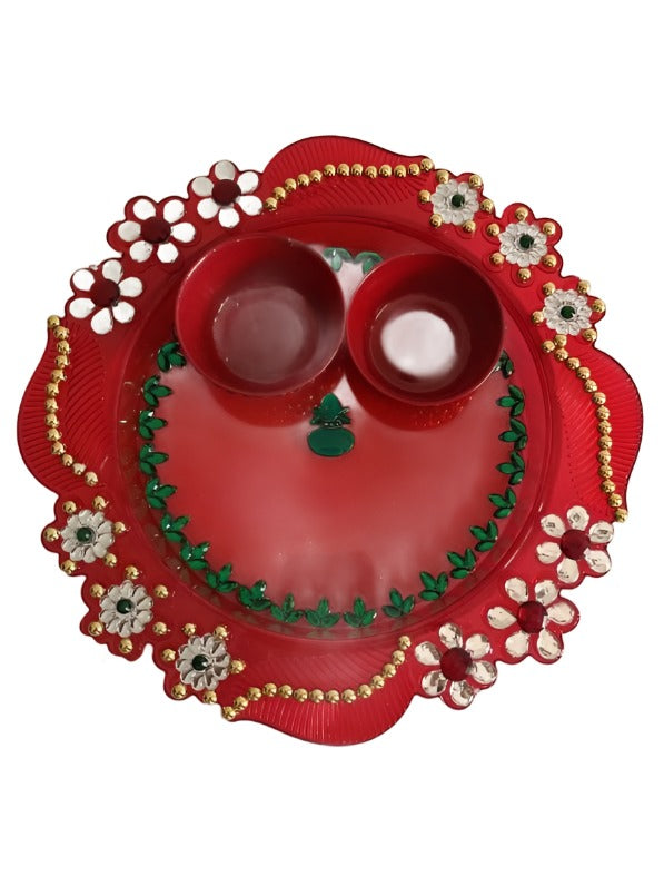 Plate with haldi kumkum and diya used to perform aarati.
